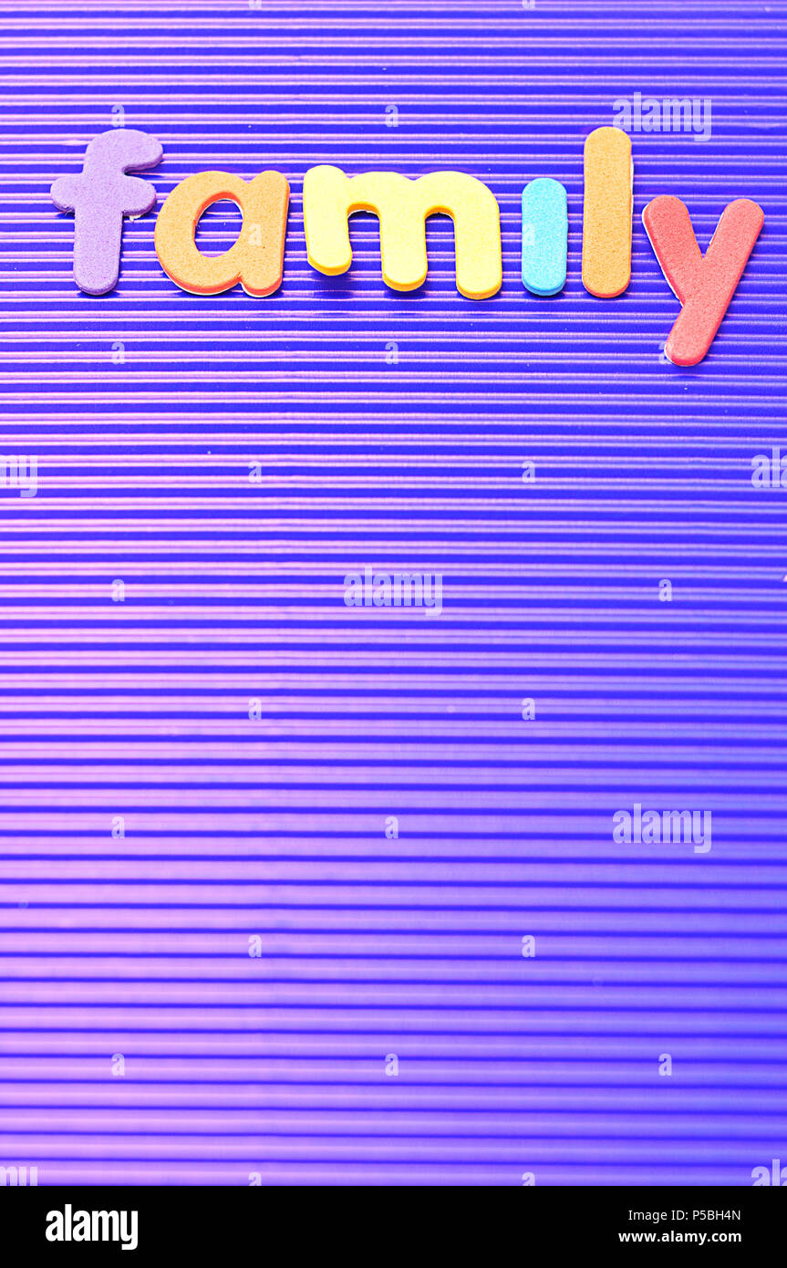 The word family in colorful letters on a blue background Stock Photo