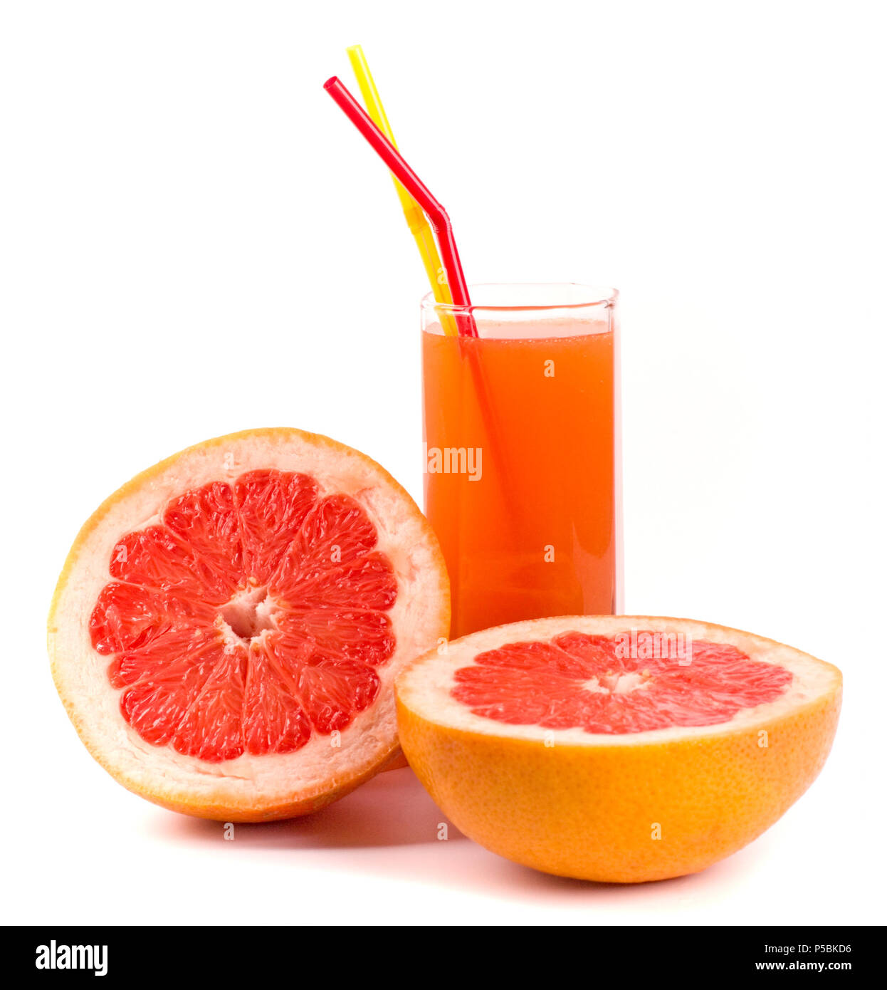 two halves of grapefruit and juice in glass on white Stock Photo Alamy