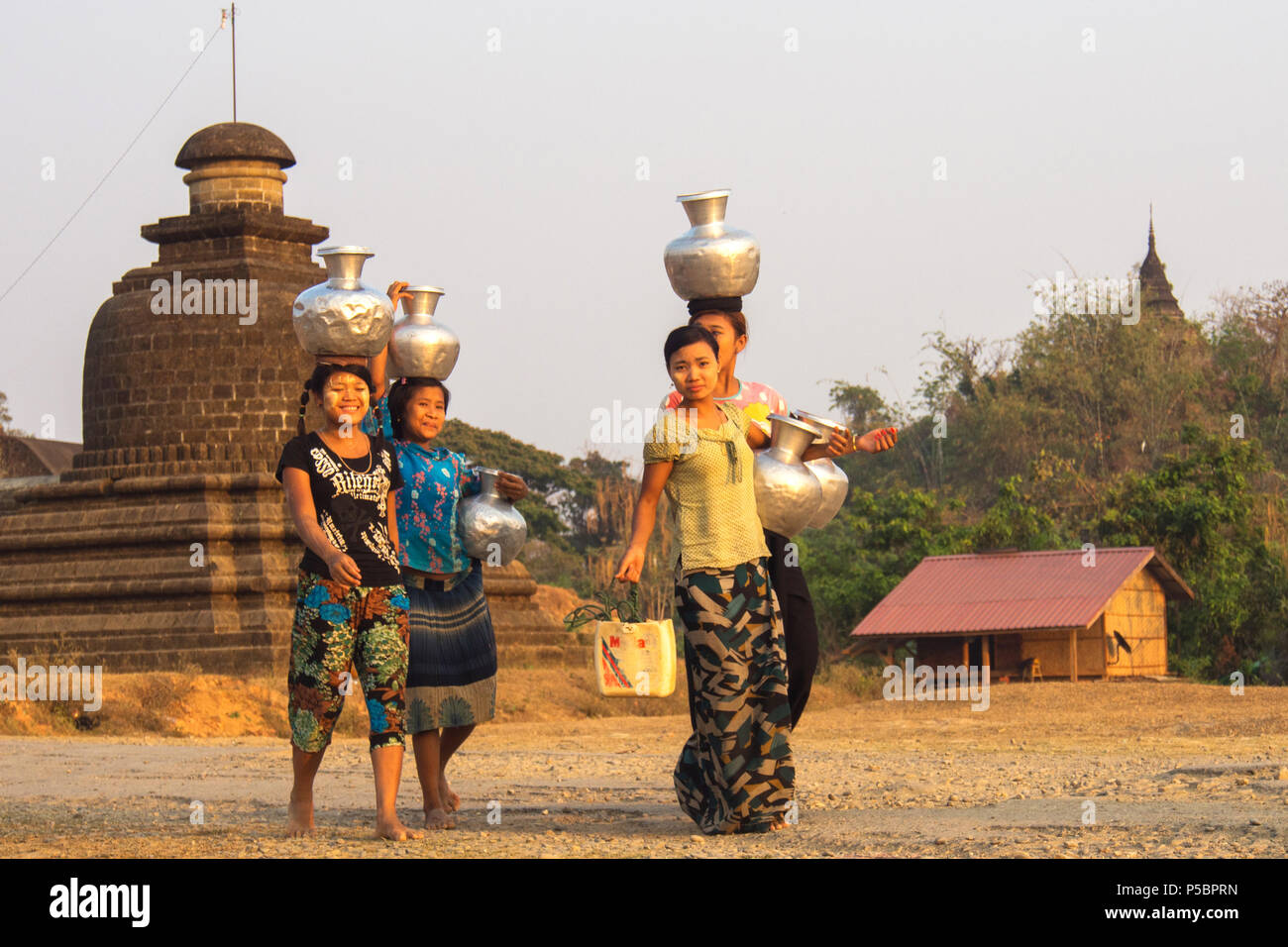 Women group was walking together from fetching water, Mrauk u Myanmar Stock Photo