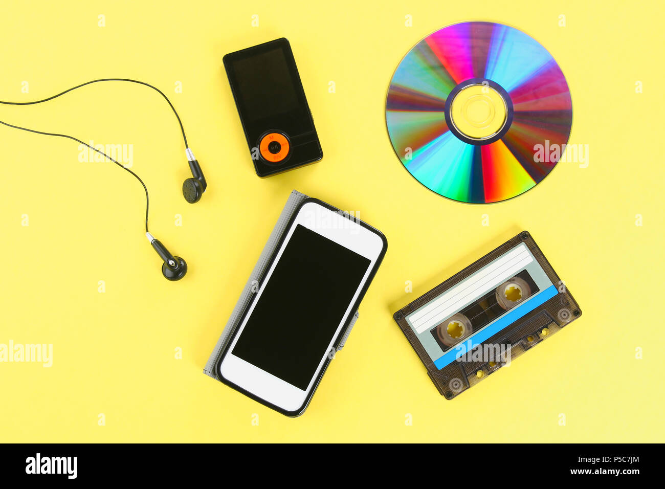 The concept of the evolution of music. Cassette, CD-disk, mp3 player, mobile phone. Vintage and modernity. Music support Stock Photo