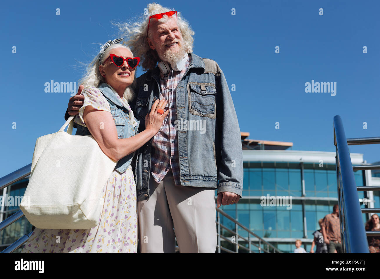 Pleasant aged woman hugging her man Stock Photo