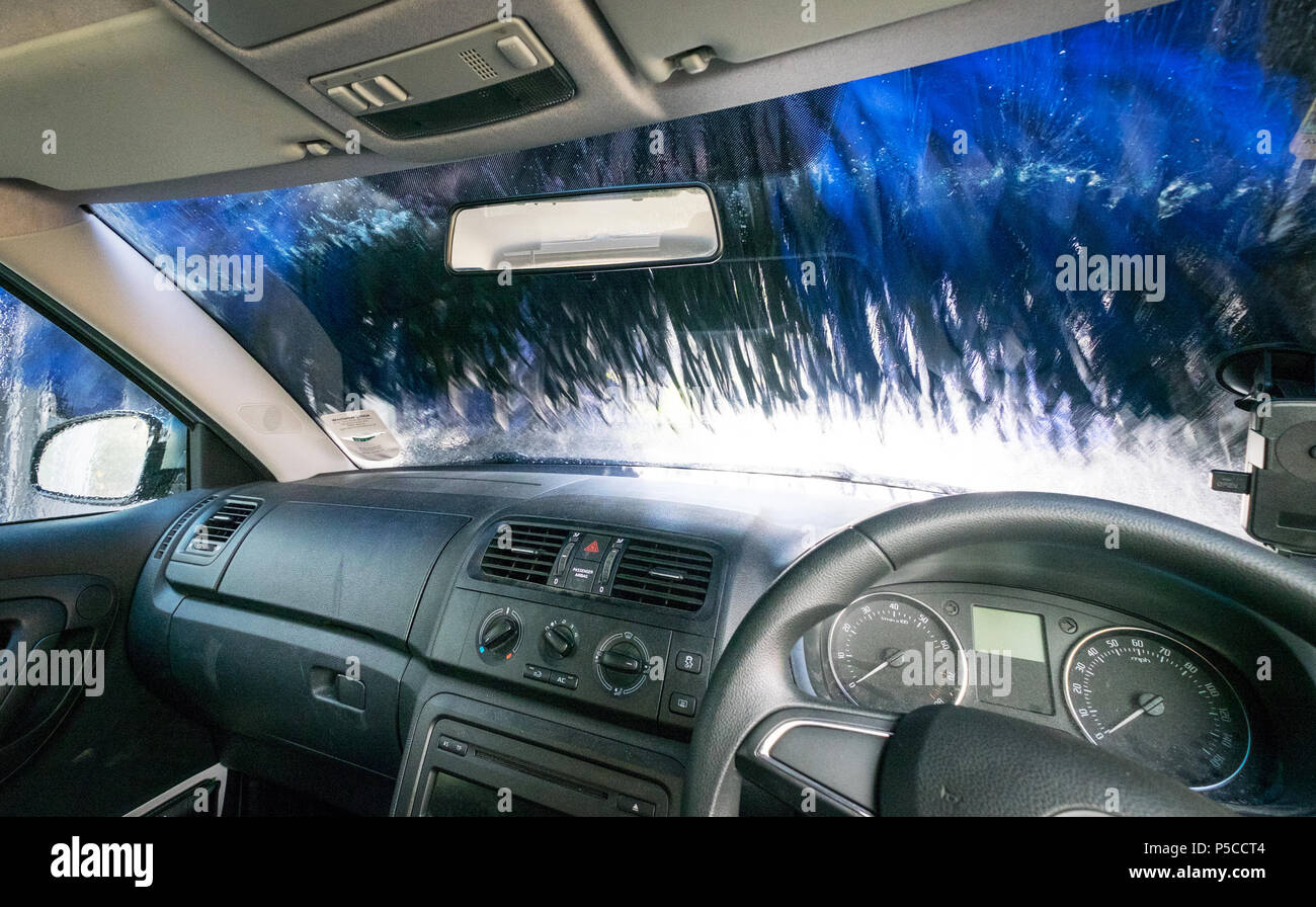 Car in an automatic car wash from inside looking out to illustrate autoplenophobia, the fear of car washes Stock Photo