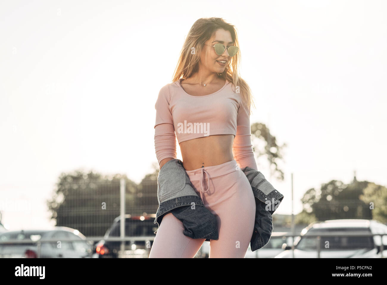Portrait of Young and Beautiful Woman in Casual Clothes in the Street.  Dressed in Pink Shirt and Pants. Spring, Summer Concept. Relax Time. Girl  with Stock Photo - Alamy