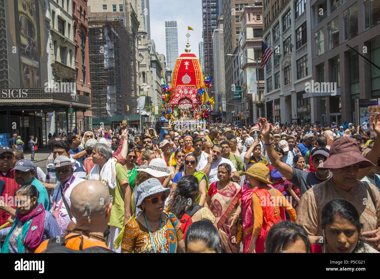 People numbering in the thousands fill 5th Avenue in Manhattan for the 'Festival of the Chariots.' 'Ratha-yatra, or the Festival of Chariots, is a joyous event celebrated for thousands of years in the Indian holy city of Jagannatha Puri, and more recently by Hare Krishna devotees in cities around the world. Stock Photo