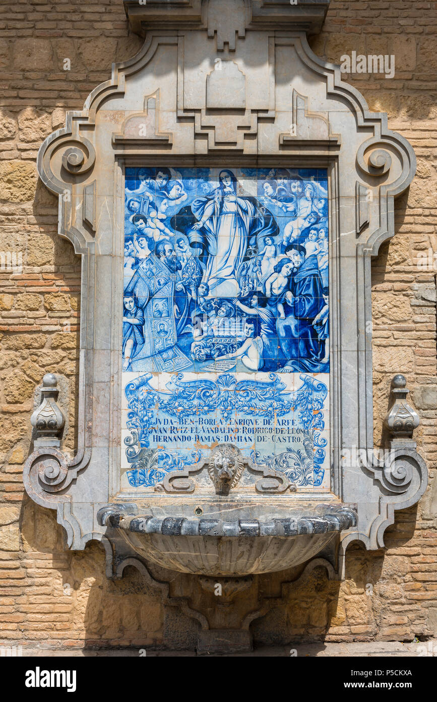 Spain tile, a Madonna composed of azulejo tiles set in a fountain sited on a wall in the Calle Compas de San Francisco in Cordoba, Andalucia, Spain. Stock Photo