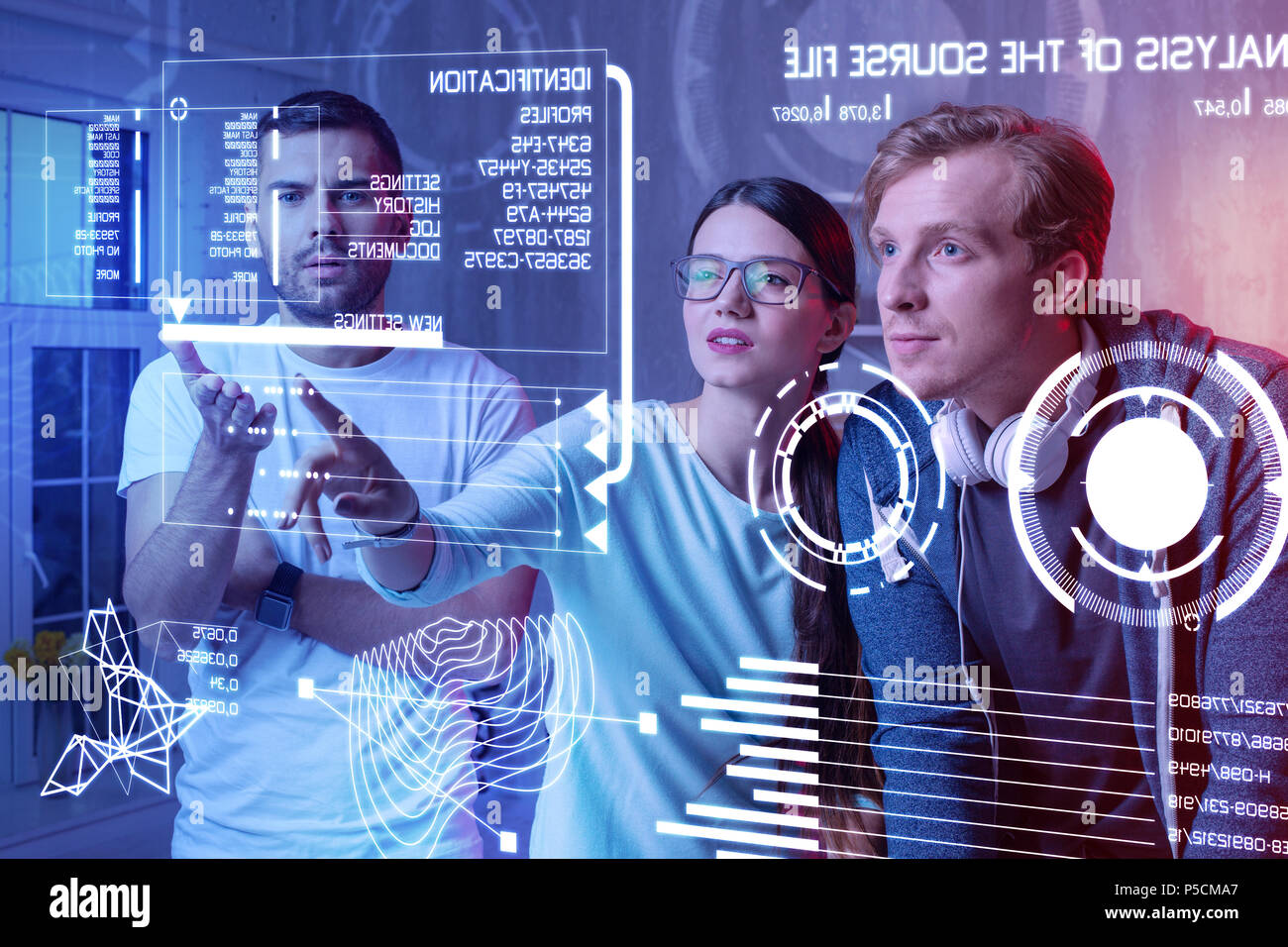 Thoughtful colleagues discussing a new program and looking at the screen Stock Photo