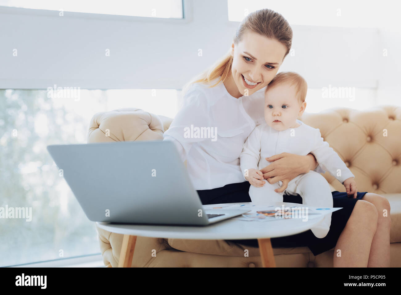 Kind female person looking at screen of computer Stock Photo - Alamy