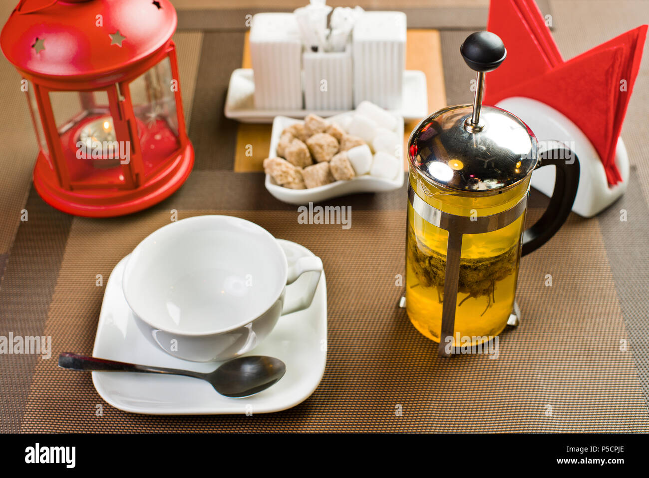 glass teapot with camomile-tea, on table in restaurant Stock Photo
