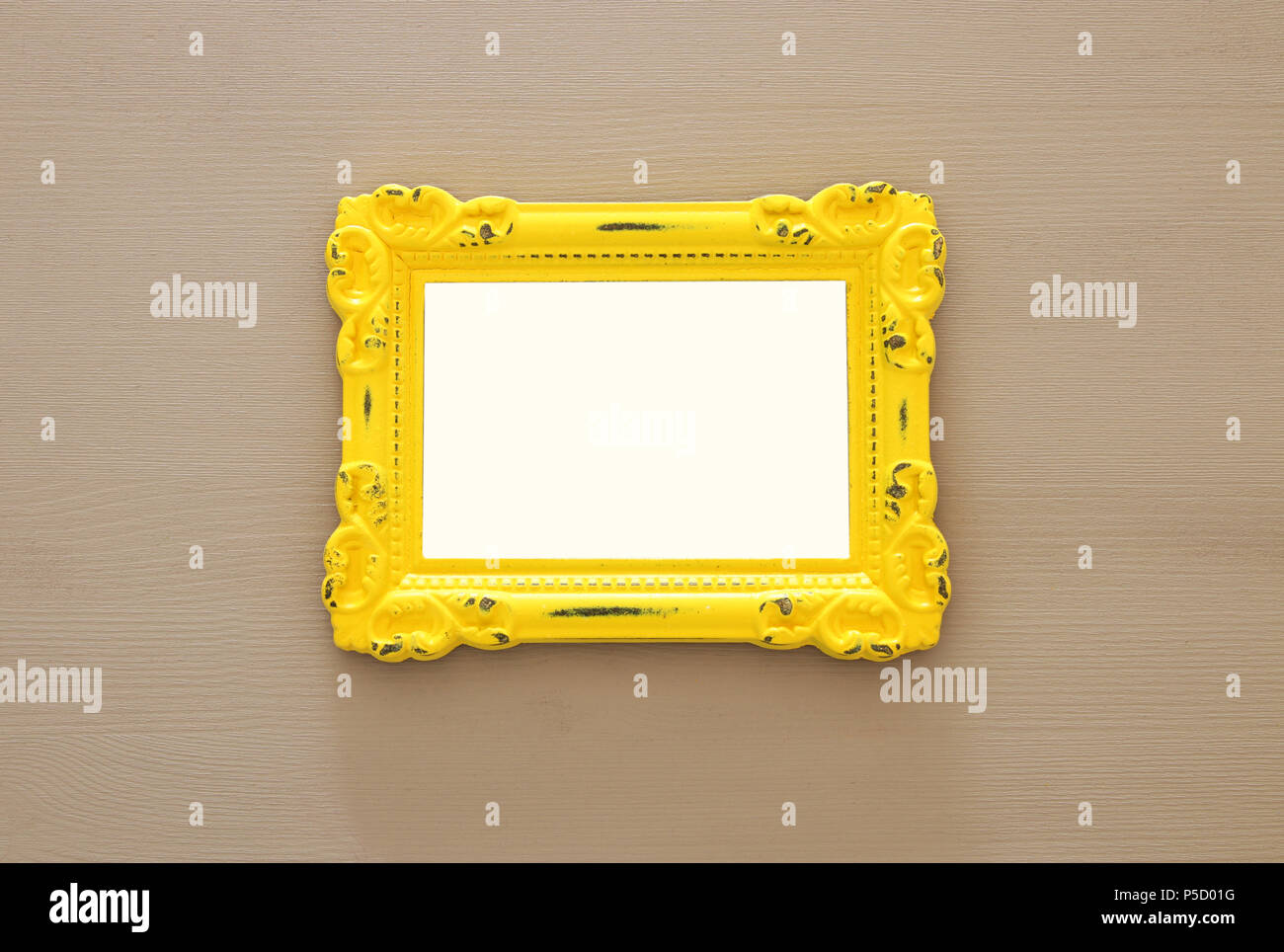 Vintage blank yellow photo frame over gray background. Ready for ...