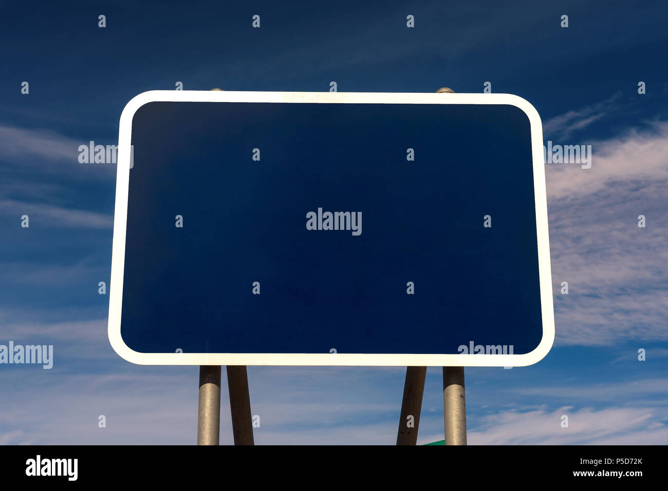 Blank road sign with blue background Stock Photo