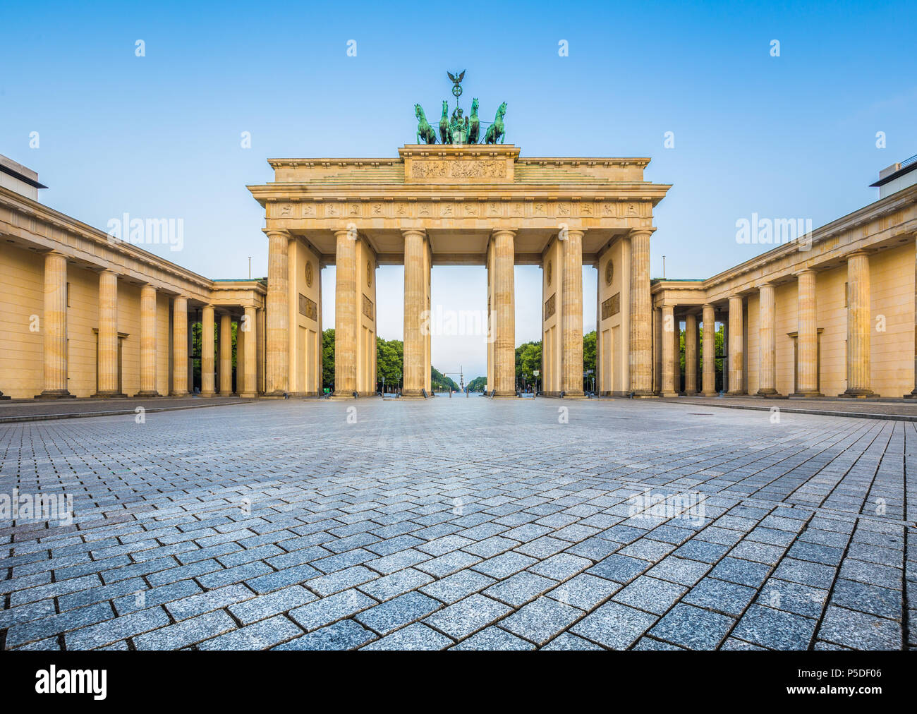 Famous Brandenburger Tor (Brandenburg Gate), one of the best-known landmarks and national symbols of Germany, in beautiful golden morning light at sun Stock Photo