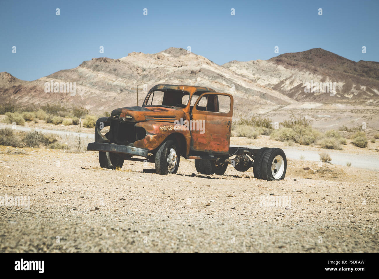 Classic view of an old rusty pickup truck car wreck in the desert on a beautiful sunny day with blue sky in summer with retro vintage VSCO Instagram s Stock Photo