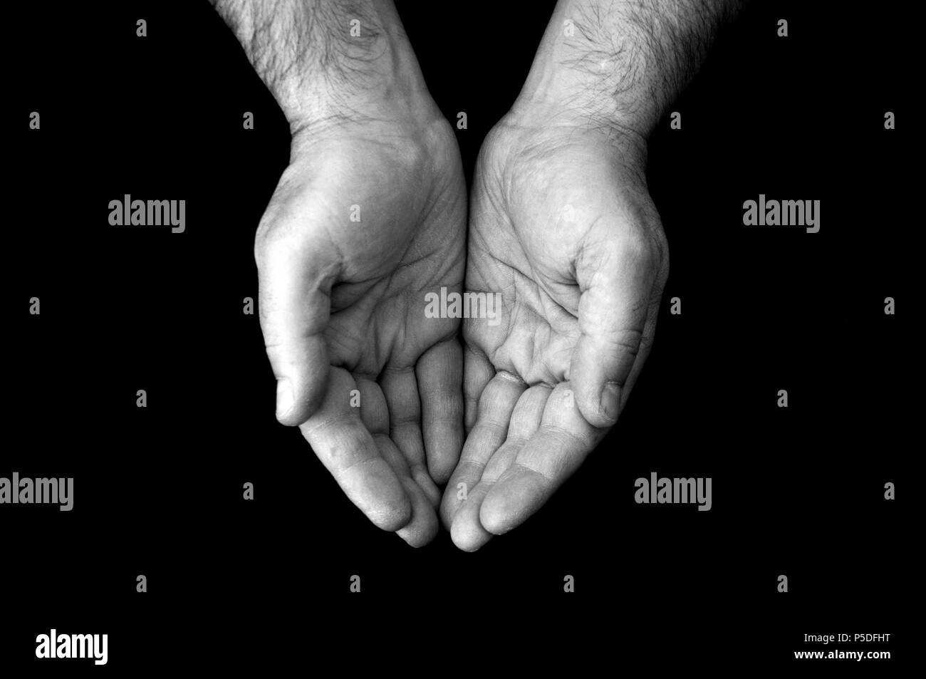 A black and white shot of a cupping pair of hands. Stock Photo