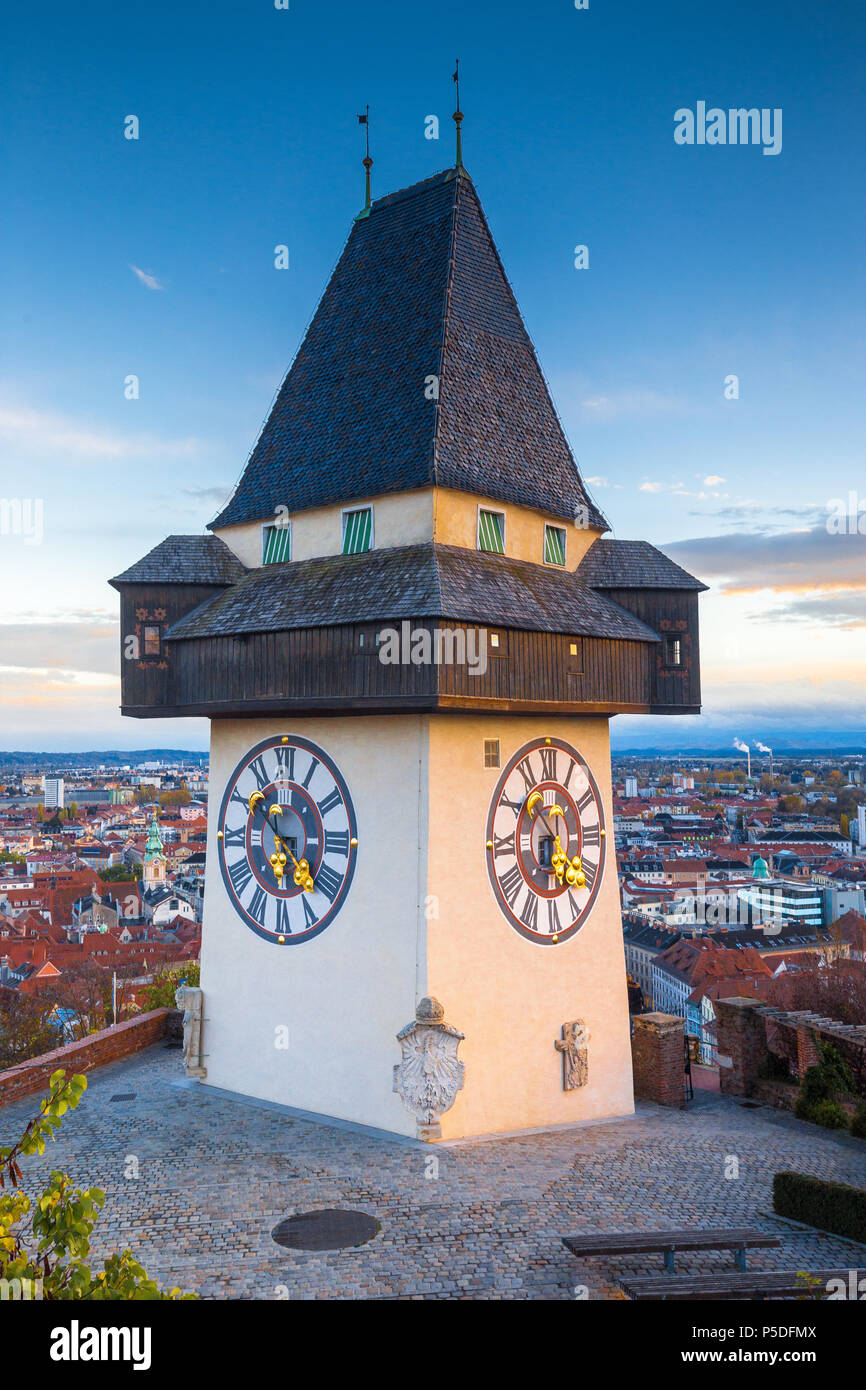 Classic view of famous Grazer Uhrturm in the historic city of Graz in beautiful evening light at sunset, Styria, Austria Stock Photo