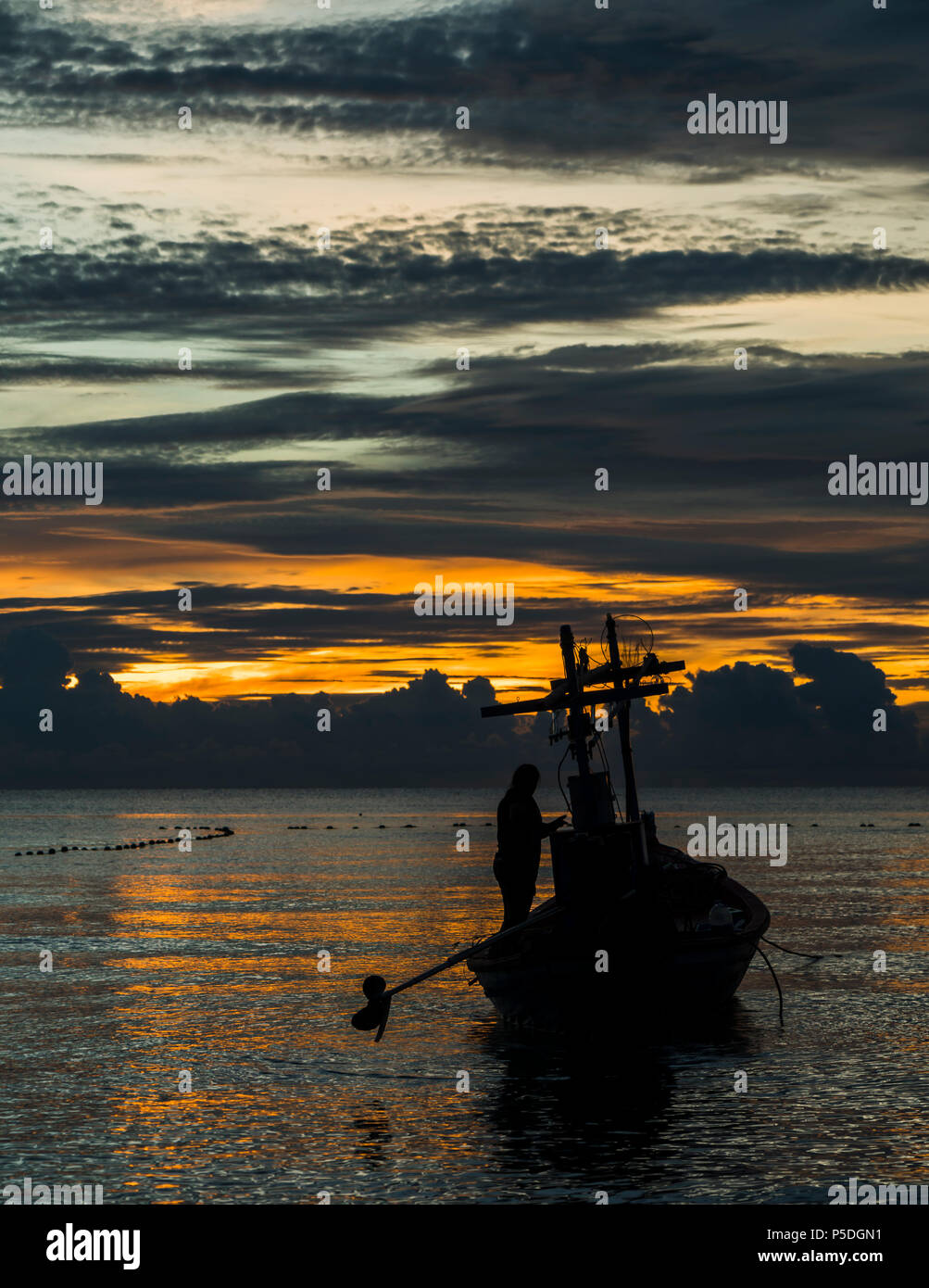 A fishing boat is ready to work in dawn. Stock Photo