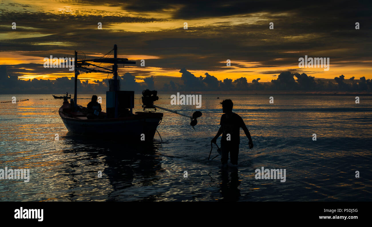 Fisherman finish work after sunset. Stock Photo