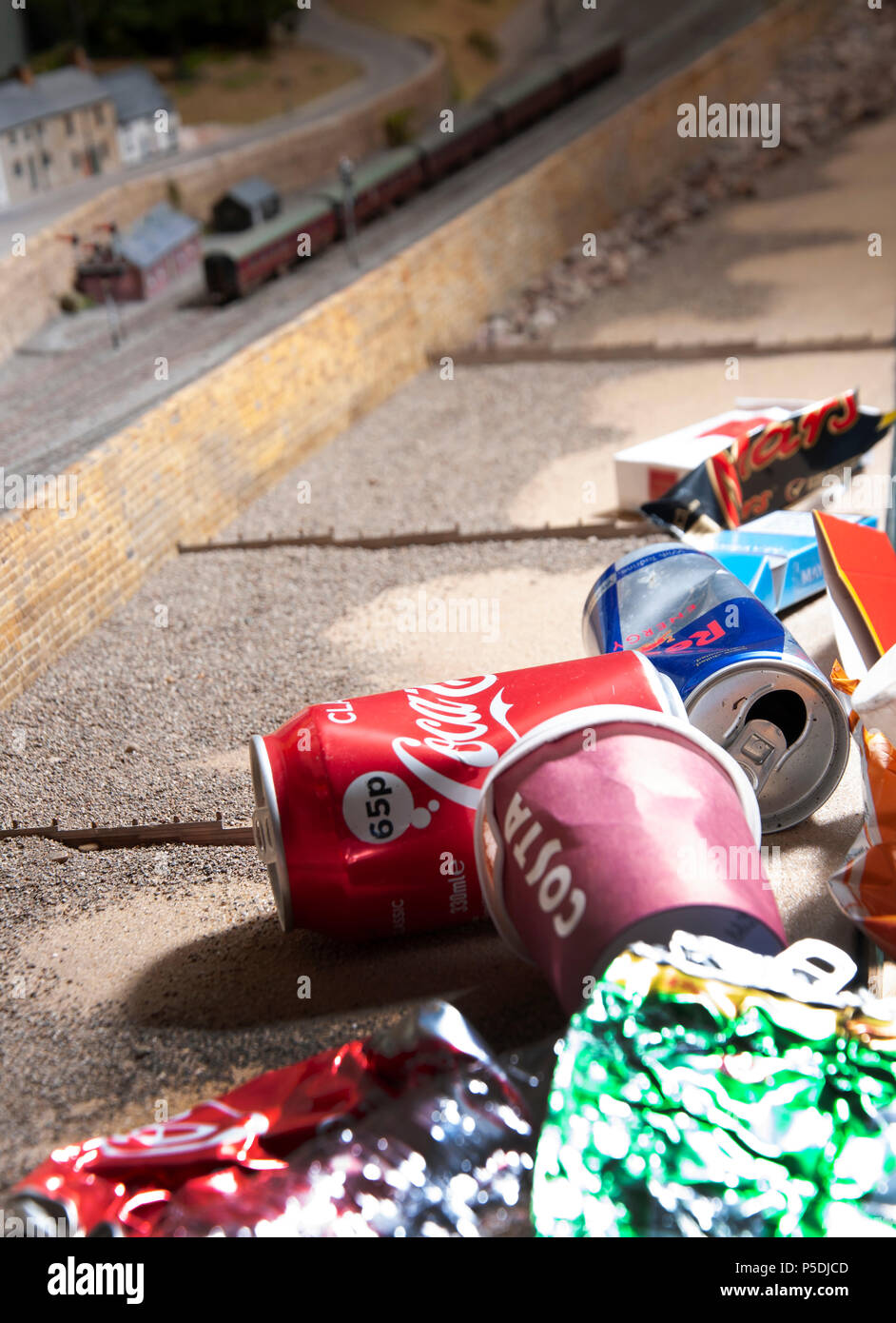 A play on scale showing the representation of the damage human waste has on the environment and Marine life. Stock Photo