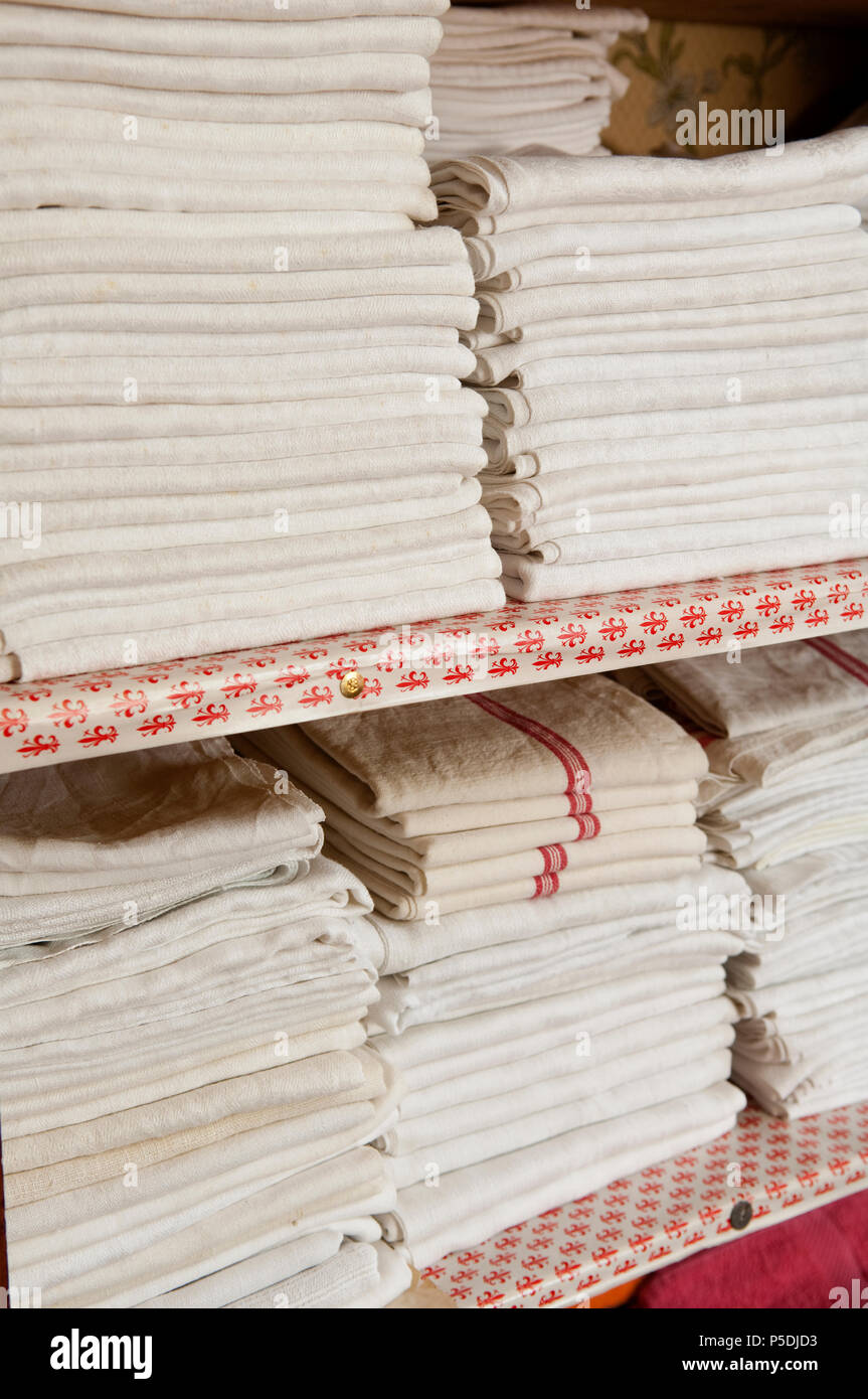 Stacked linen in linen cupboard Stock Photo