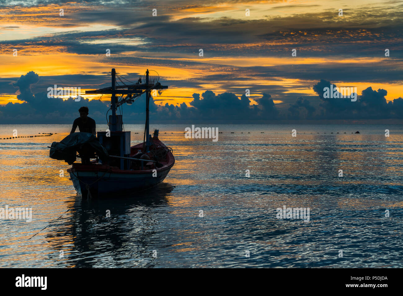 Fisherman prepare for work in dawn. Stock Photo