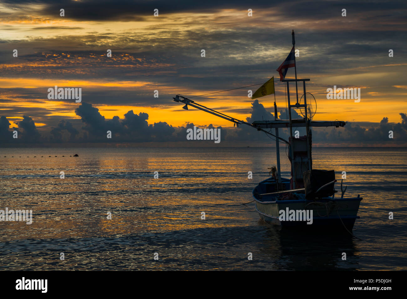 A fisherman boat in dawn Stock Photo - Alamy