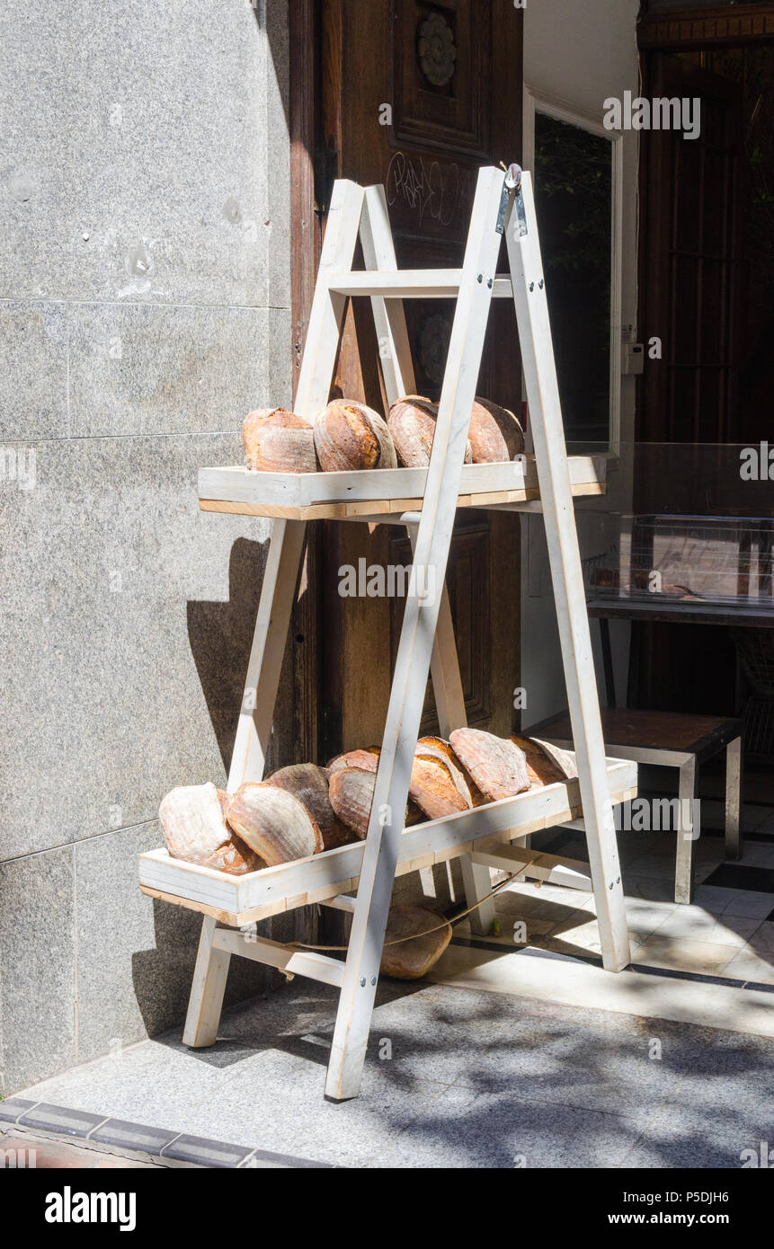 Loaves of artisan bread on wooden shelve outside a bakery in Birmingham city centre Stock Photo