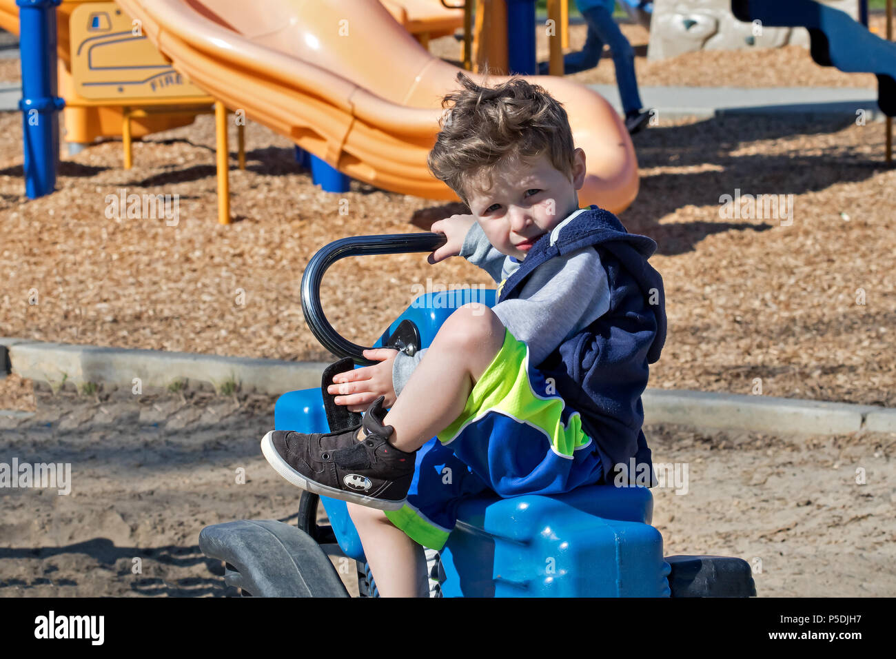 Boy child blond swing playground hi-res stock photography and images ...
