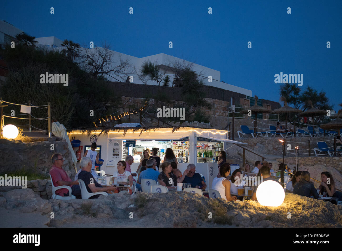 Beach Bar night Spain Mallorca, people tourists standing and sitting, Baleric Stock Photo