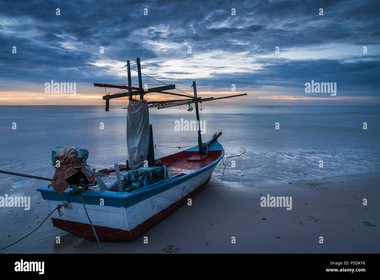 A fishing boat on beach in dawn. Stock Photo