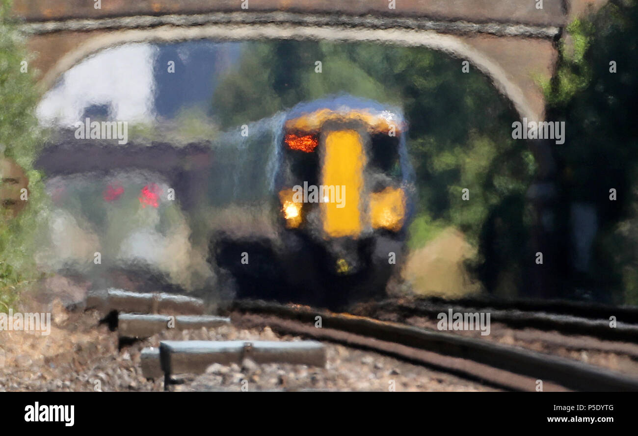 A train moves through heat haze in Ashford, Kent, as the continued hot