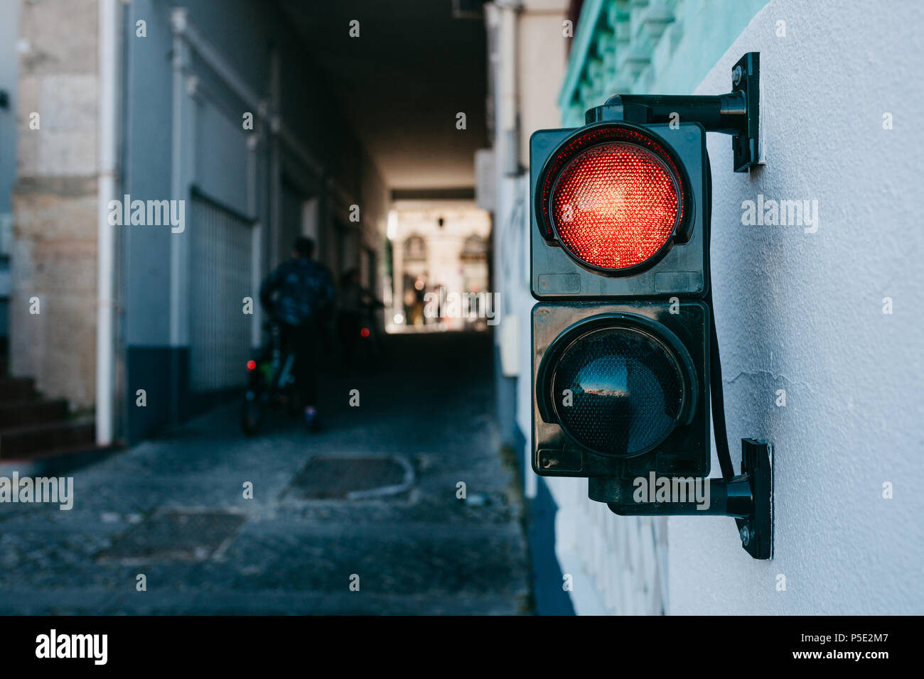 A traffic light on the wall in Lisbon in Portugal Stock Photo Alamy