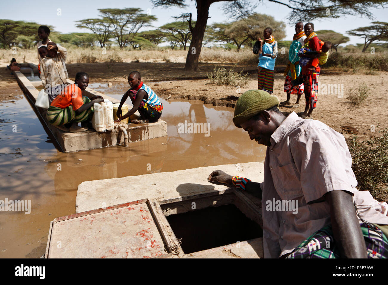 Livestock herders drive their herds to the few waterholes in the dry landscape of the provincial town Isiolo. For years northern Kenya has been suffer Stock Photo