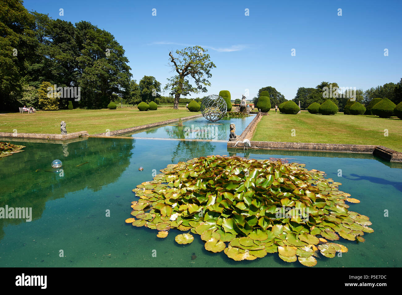 People enjoying the formal gardens and water features of Burton Agnes Hall, East Riding of Yorkshire, England, UK, GB Stock Photo