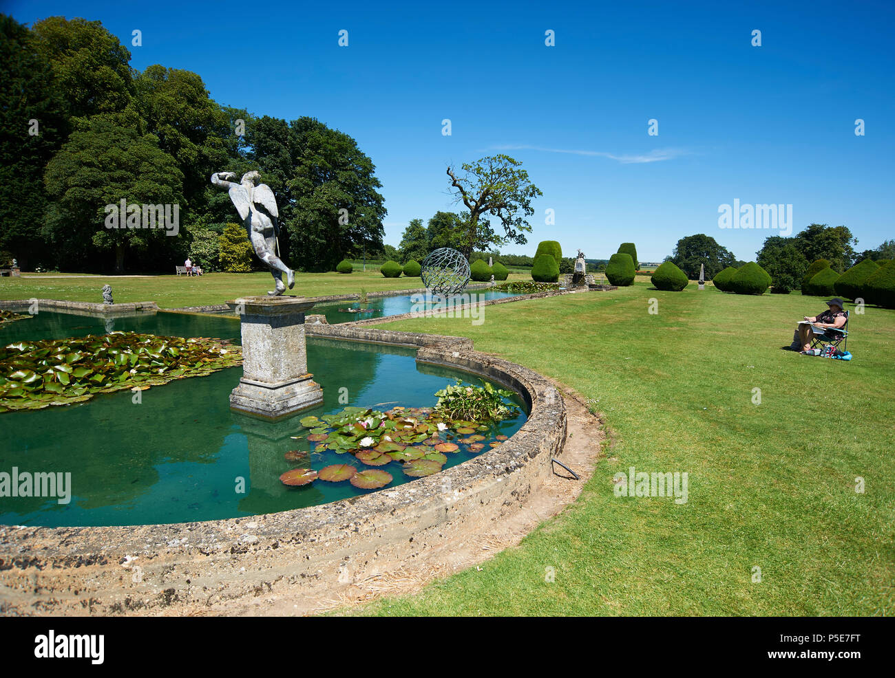 People enjoying the formal gardens and water features of Burton Agnes