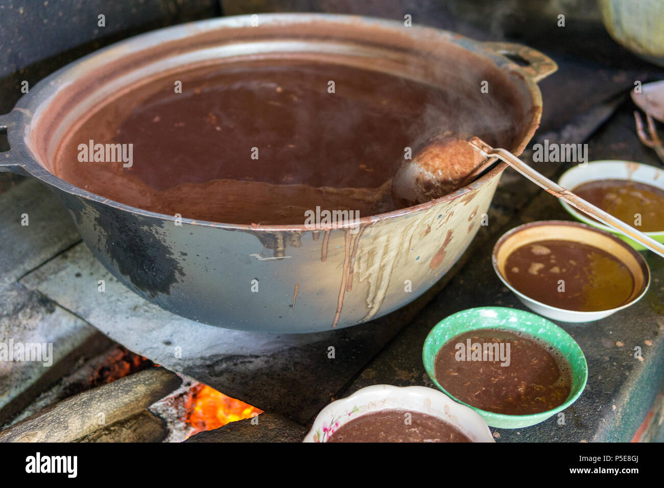 Big pot of traditional bean soup over fire in central america Stock