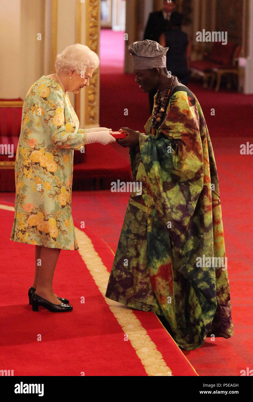 Mr. Brima Manso Bangura from Sierra Leone receives his Young Leaders Award from Queen Elizabeth II during a ceremony in the Ballroom at Buckingham Palace. Stock Photo
