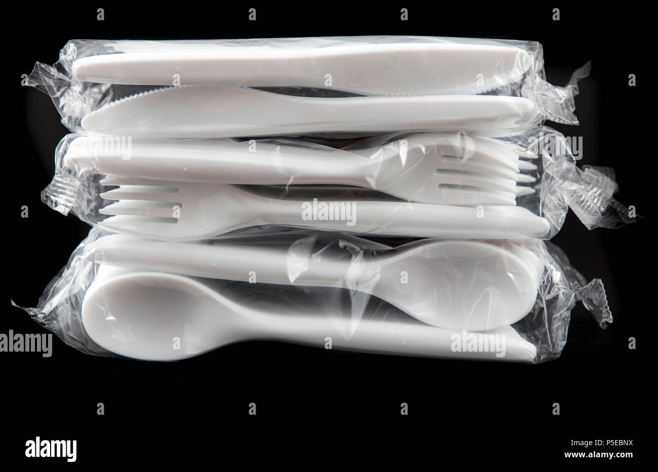 Large pack of plastic cutlery, disposable cutlery, knives, forks, spoons, plastic waste, Stock Photo