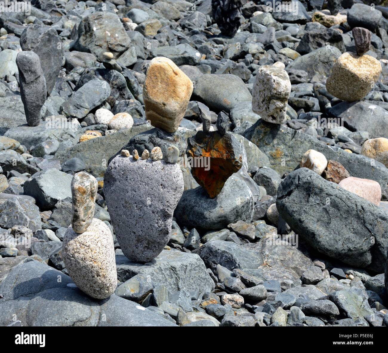 Large stones and pebbles balancing on a pebble beach,St Ives,Cornwall,England,UK Stock Photo