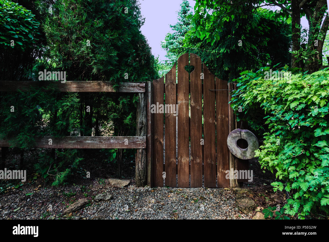 Old wooden fence and wicket in home garden Stock Photo