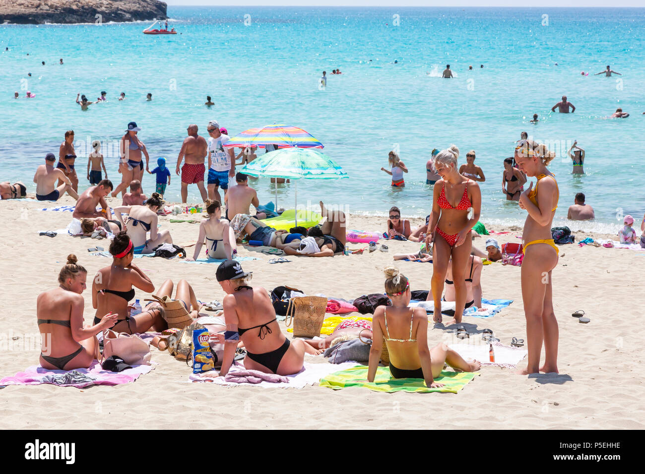 Group of young women sunbathing on the beach at Nissi Bay, Ayia Napa, Cyprus Stock Photo