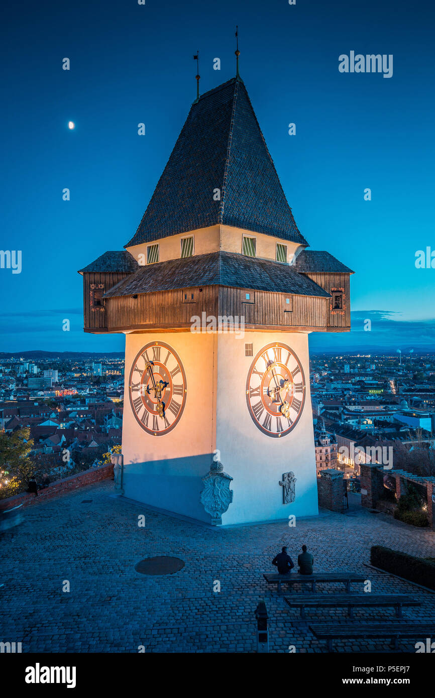 Beautiful twilight view of famous Grazer Uhrturm (clock tower) illuminated during blue hour at dusk, Graz, Styria region, Austria Stock Photo