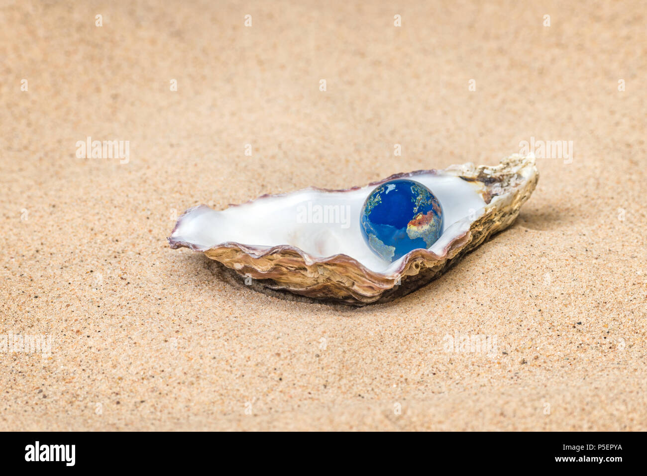 Concept image based on the metaphor - The World is your Oyster, a good image to represent future Opportunity, Fortune and Success type themes. Stock Photo