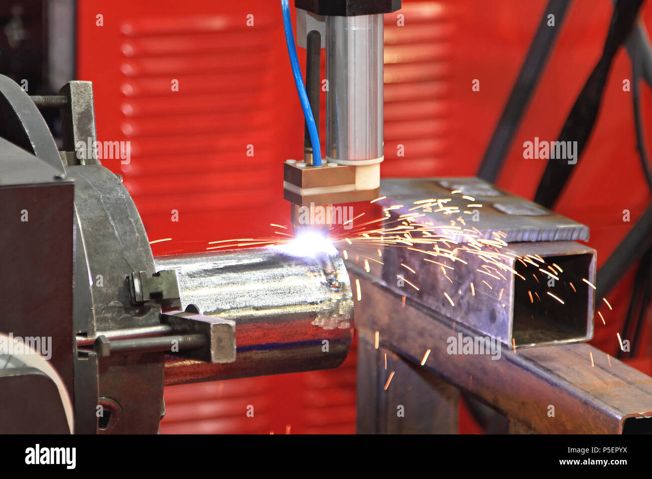 Automated Robot Welding Pipe in Factory Stock Photo
