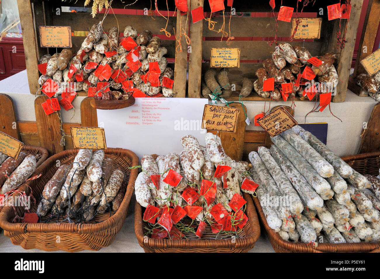 Different varieties of saucisson in a French market stall. Please note that the labels indicate ingredients for the sausages, not brand names, so no c Stock Photo