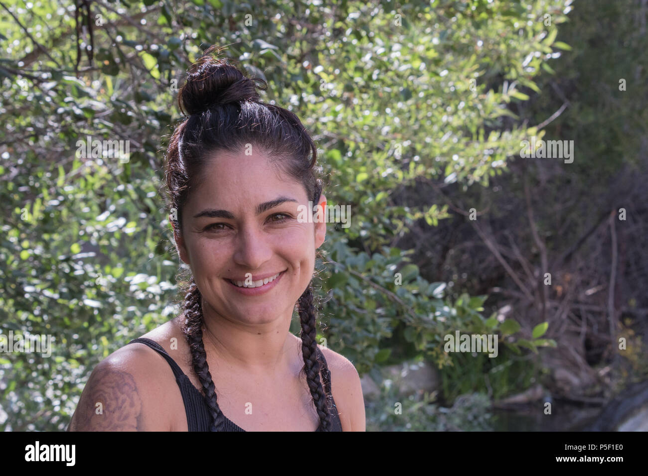 Happy, laughing profile of an attractive Spanish America Hispanic Mexican woman in nature on vacation Stock Photo