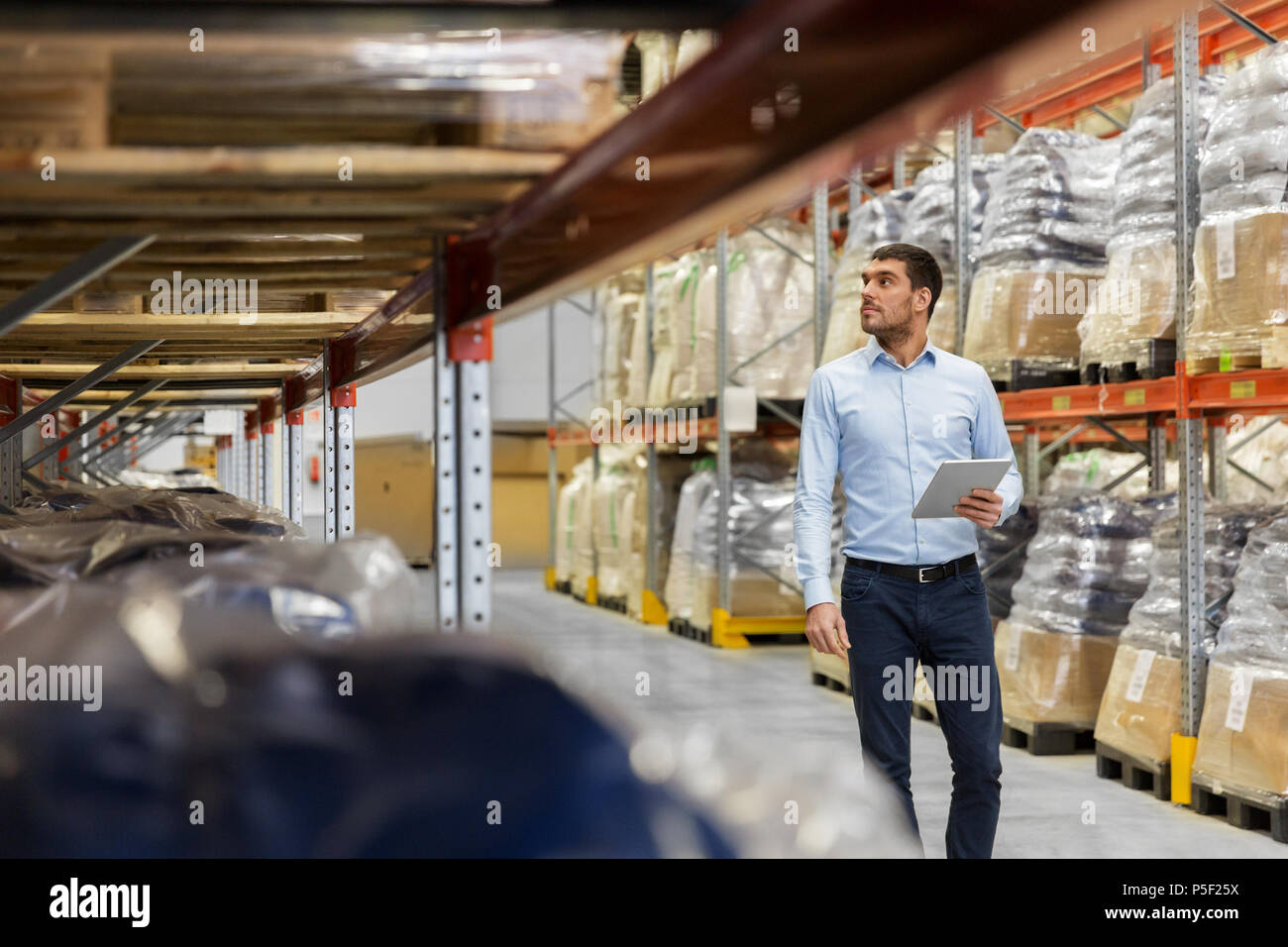 businessman with tablet pc at warehouse Stock Photo