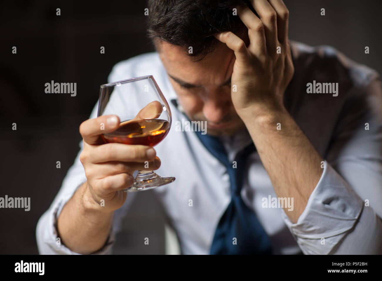 close up of drunk man drinking alcohol at night Stock Photo Alamy