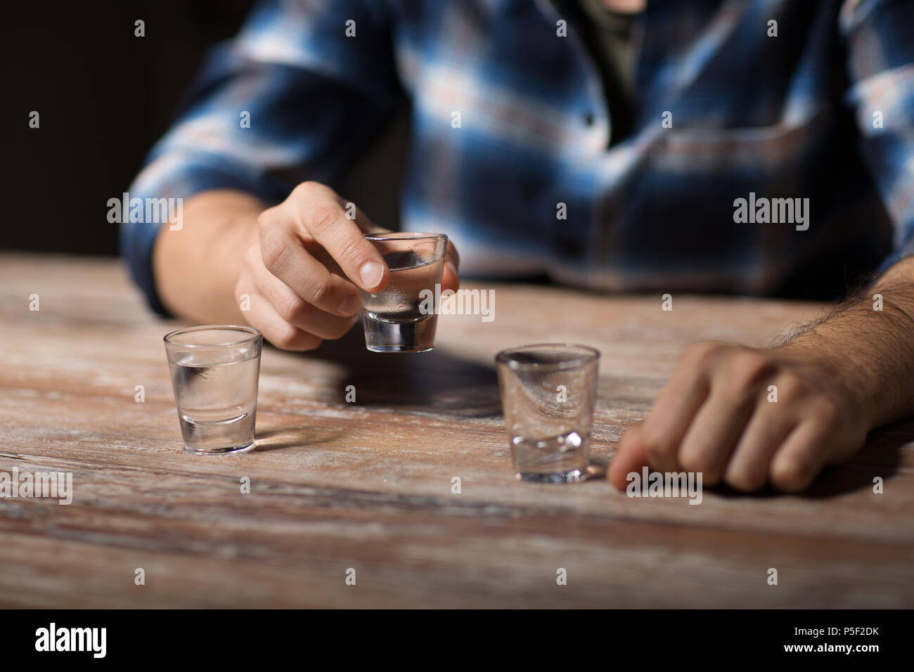 hands of alcoholic drinking vodka shots at night Stock Photo Alamy