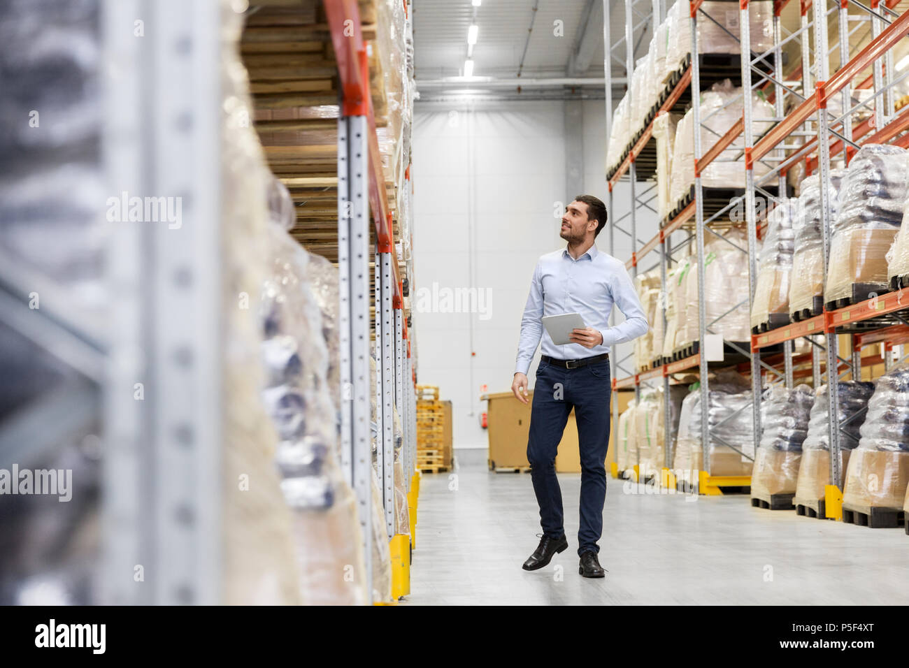 happy businessman with tablet pc at warehouse Stock Photo