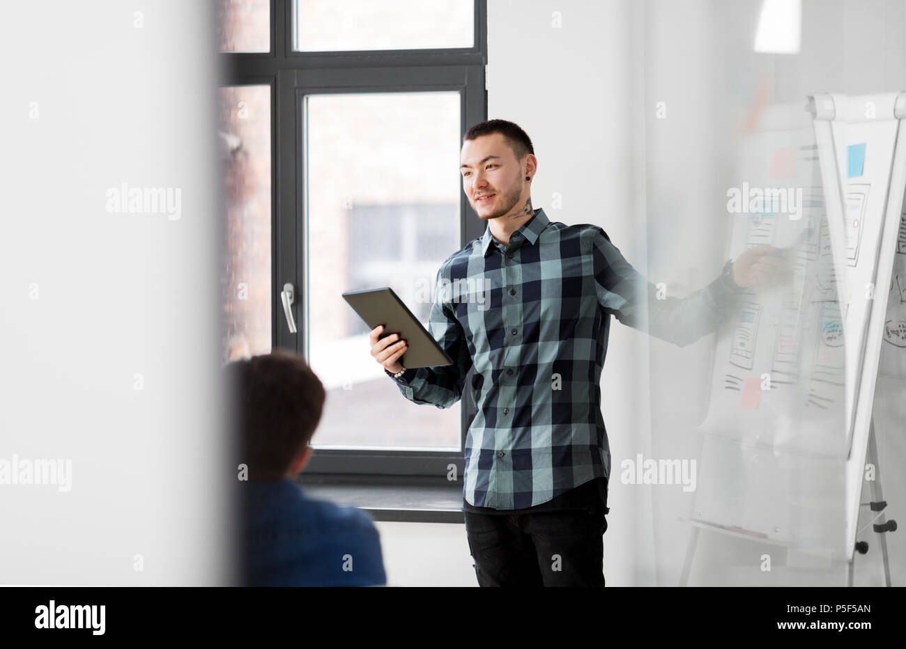 man showing tablet pc to creative team at office Stock Photo