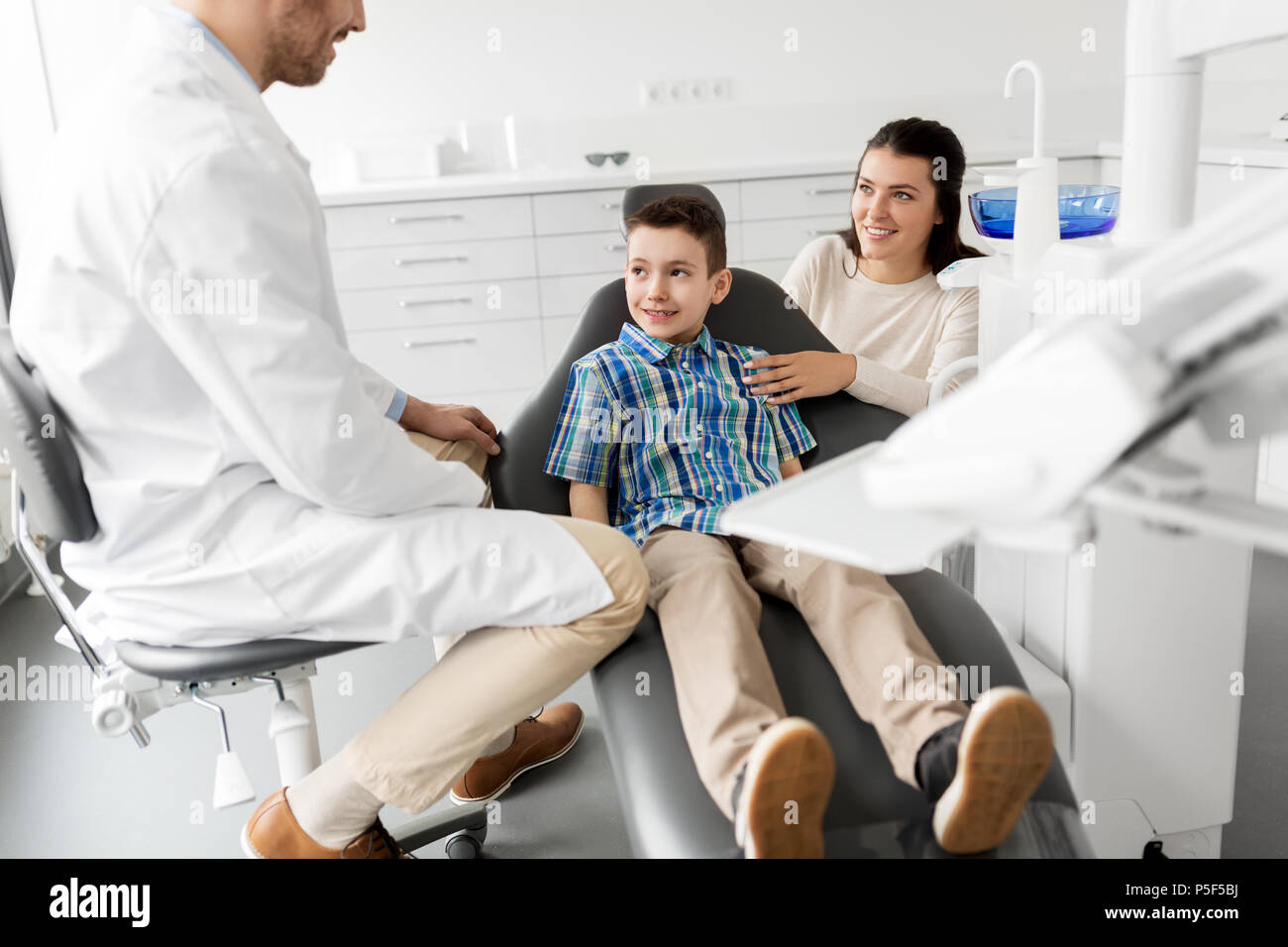 mother and son visiting dentist at dental clinic Stock Photo Alamy